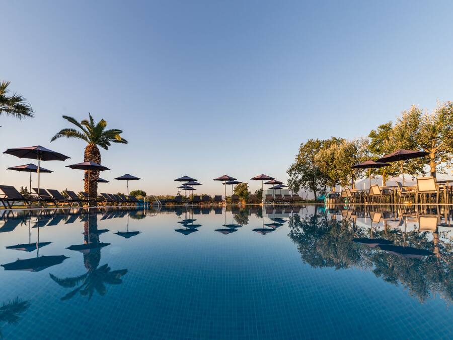 2 outdoor pools, open 11:00 AM to 8:00 PM, pool umbrellas, pool loungers