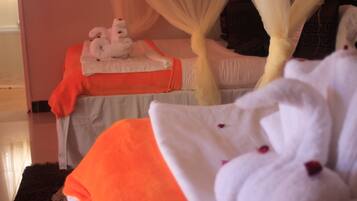 Cozy retreat with a white canopy bed and plush bedding.