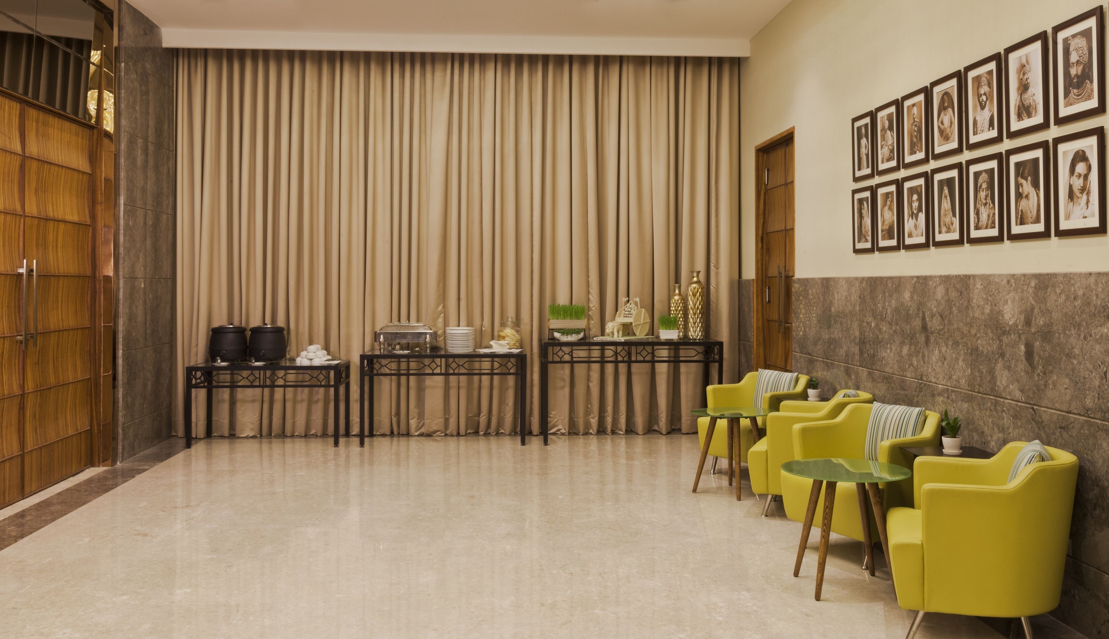 A conference room with a long table, chairs, and a backdrop of vertical blinds.