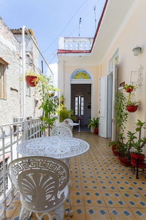 Enjoy dining or socializing in this charming courtyard with a beautifully tiled floor and ornate metal table.