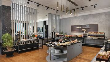 A modern buffet setup with a variety of food items and a central serving station.