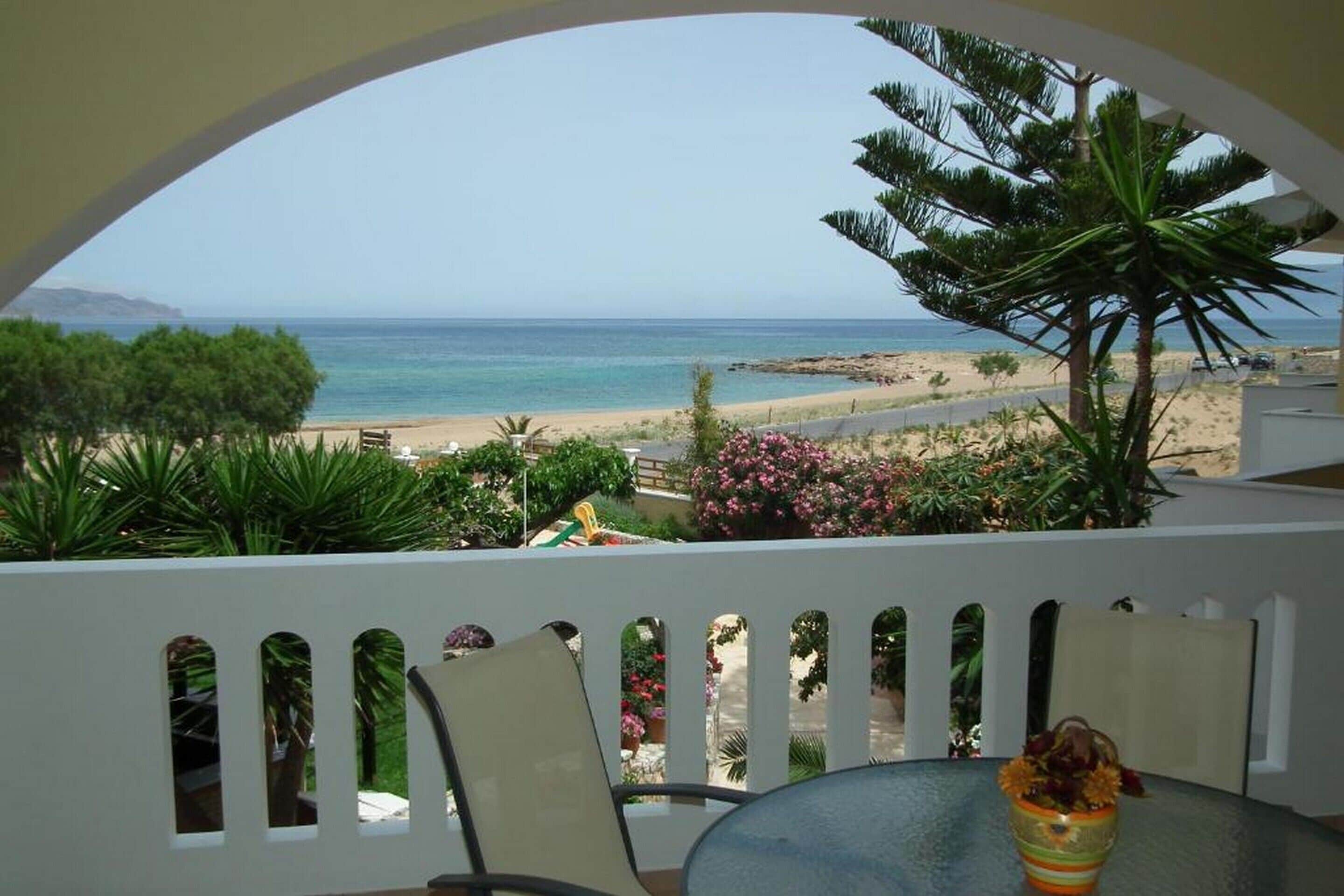 Un balcón con vista a la playa y al océano.