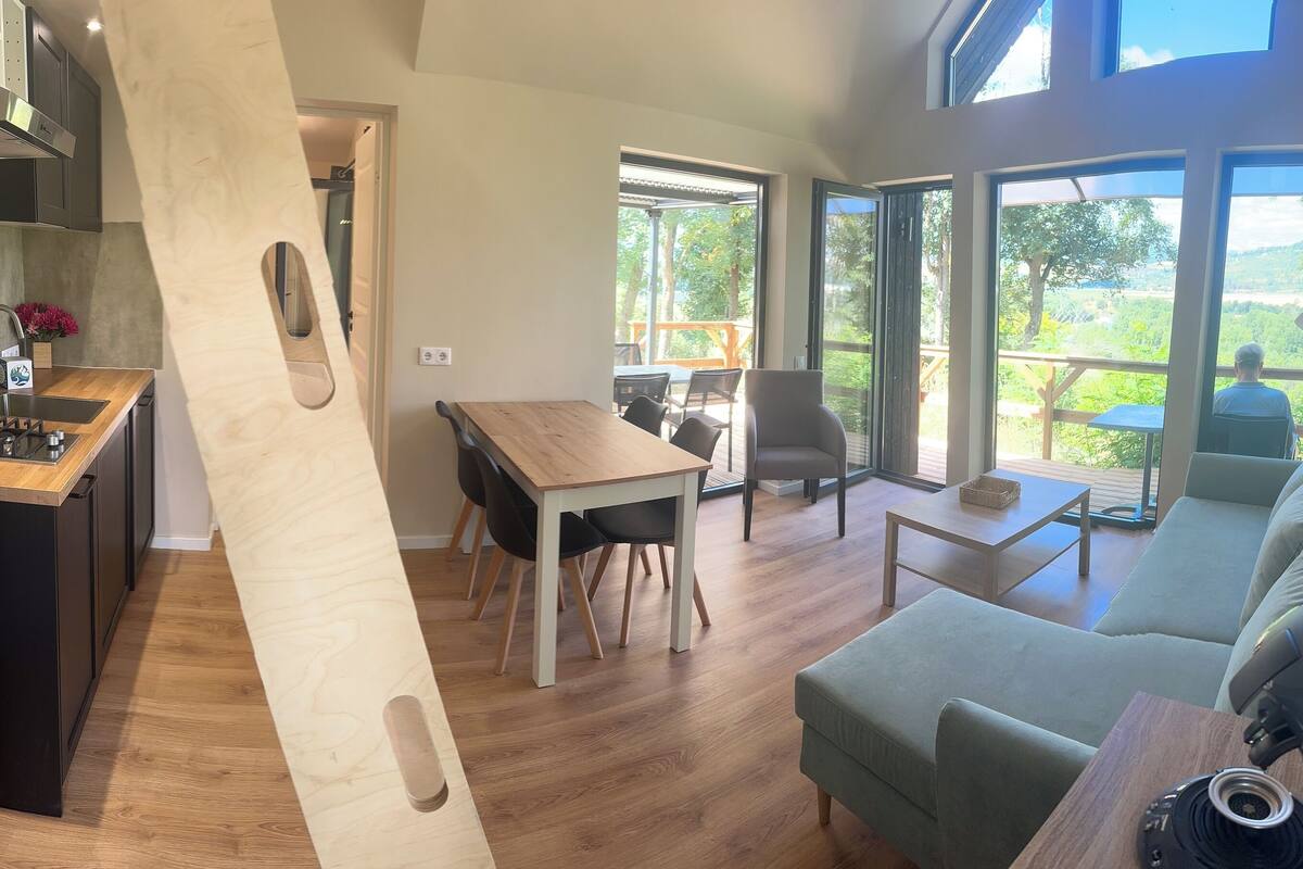 elite cottage, 1 queen bed, river view | living area | flat-screen tv, fireplace