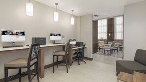 A modern office space with multiple workstations, ergonomic chairs, and pendant lighting. - Staybridge Suites Florence - Civic Center by IHG (Florence)