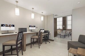 A modern office space with multiple workstations, ergonomic chairs, and pendant lighting. - Staybridge Suites Florence - Civic Center by IHG (Florence)