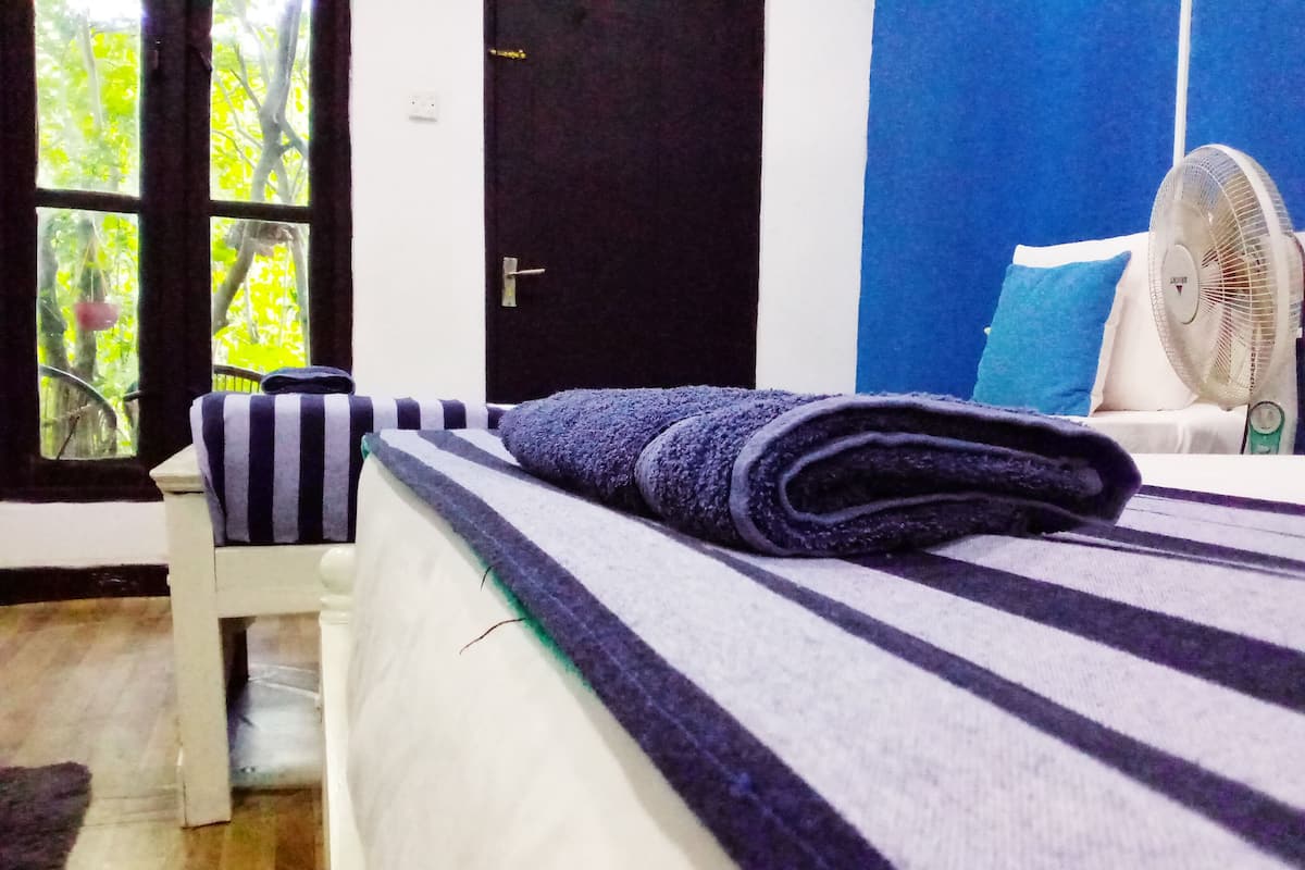 Deluxe Triple Room, 1 Bedroom, Garden View, Garden Area | In-room safe, desk, laptop workspace, soundproofing