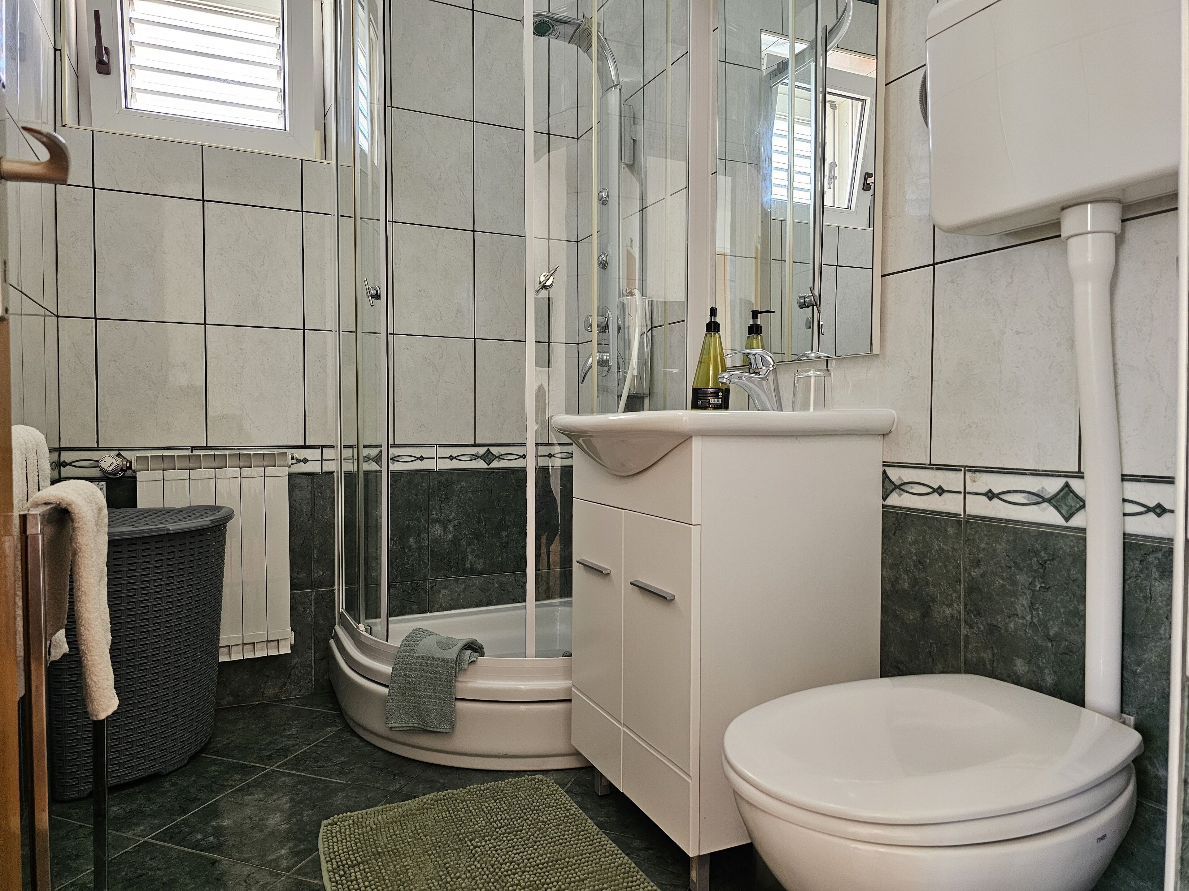 A bathroom with a bathtub, a toilet, a sink, and a shower.