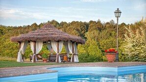 A swimming pool with a gazebo and seating area, surrounded by greenery and a lamp post. - Villa Sant' Angelo - Villa with private pool (Poppi)