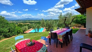 A patio with a pool, outdoor seating, and a view of the countryside. - Villa Ulivi - Holiday Country Villa in Lucignano, Valdichiana, Tuscany (Lucignano)
