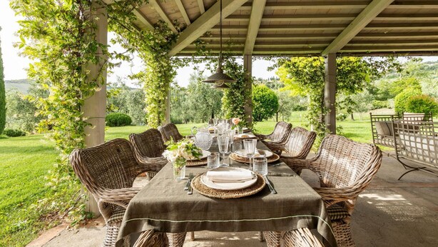 An outdoor dining area with wicker furniture and a table set for four. - Villa Danilo - Luxury Holiday Villa with private swimming pool in San Casciano dei Bagni, Orcia ... (San Casciano Dei Bagni)