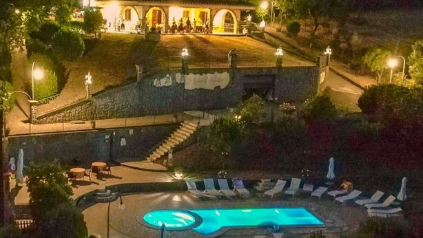 A building with a swimming pool, outdoor seating, and a staircase leading to the upper level. - I Gigli di Bolsena - Exclusive Villa Rental in Montefiascone, Lake Bolsena (Montefiascone)