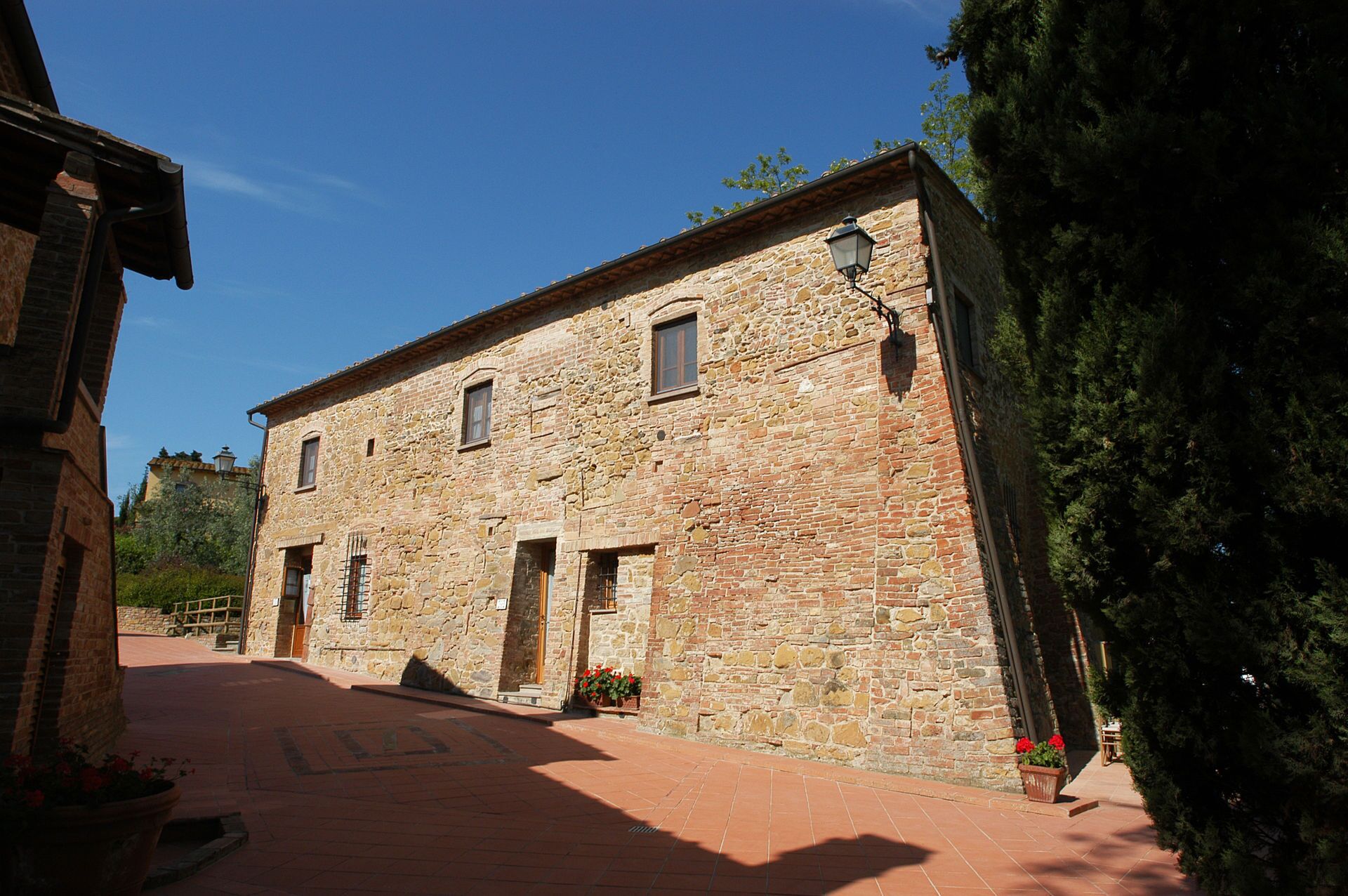 Un bâtiment en pierre avec une entrée carrelée et une petite fenêtre.