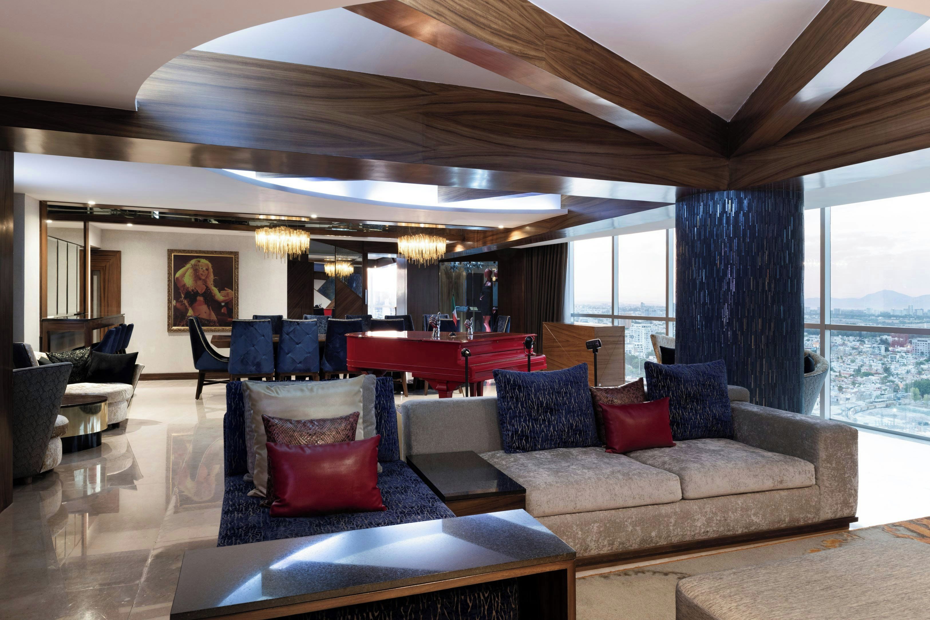 A modern living room with a piano, sofas, and a large window offering a city view.