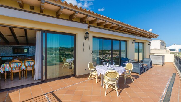 A covered outdoor dining area with a table and chairs, a sofa, and a TV screen. - CA'N NADAL - ADULTS ONLY - Beautiful townhouse with great views. Free WiFi. (Sineu)