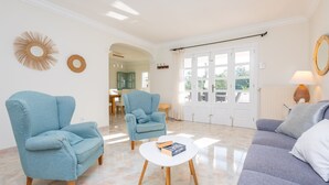 A living room with two armchairs, a sofa, and a coffee table.