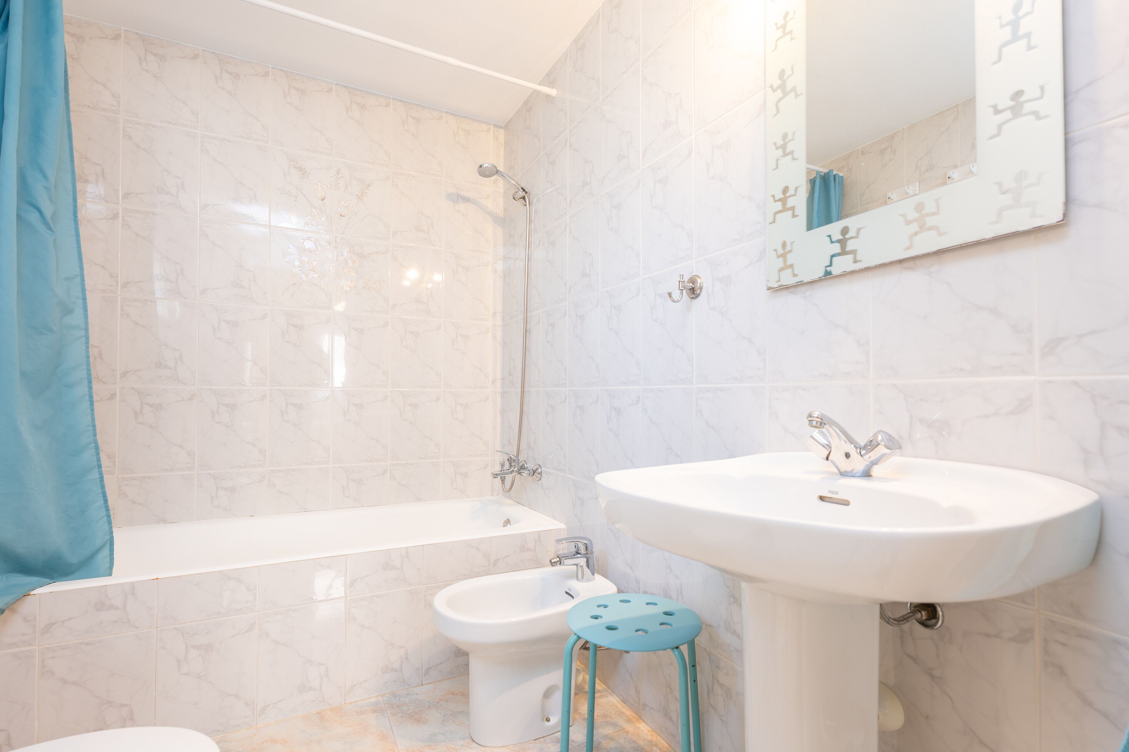 A bathroom with a bathtub, a sink, and a bidet.