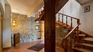 A spacious interior with a stone wall, wooden staircase, and a radiator. - Villa in Vicchio with 4 bedrooms sleeps 8 (Vicchio)