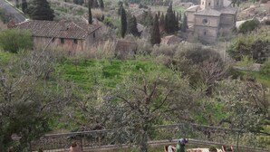 A terrace with a table and chairs overlooking a rural landscape with a church and houses. - Lovely apartment for 4 people with WIFI, A/C, TV and panoramic view (Cortona)