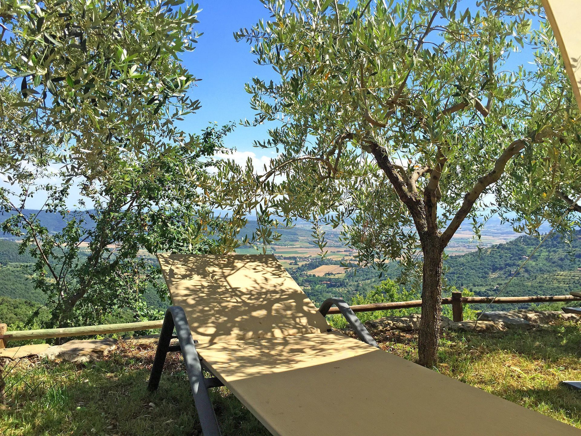 A picnic table with a view of a hilly landscape.