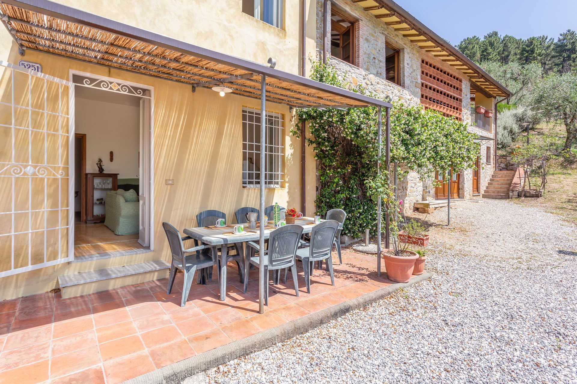A rustic stone building with a covered patio and outdoor seating area.