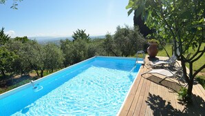 A rectangular swimming pool with clear blue water, surrounded by a wooden deck and lush greenery. - Stunning private villa with private pool, A/C, internet, TV, patio, panoramic view, close to Lucca (Vicopelago)