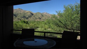 A room with a view of mountains and greenery. - Amazing Mountain Views from this 2nd Floor Large 2 Bedroom in Ventana Canyon! (Tucson)