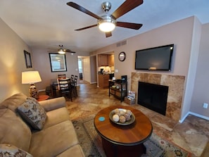 Relax in this stylish living room with a comfortable sofa, coffee table, and fireplace.