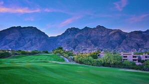 A golf course with a mountain backdrop and residential buildings. - Stunning - Inside and out! Beautiful Inside and Views of the Catalinas! (Tucson)