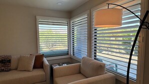 A living room with two sofas, a coffee table, and a floor lamp. - Best VIEWS & largest Extended Patio in the entire community of The Greens (Tucson)