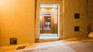 A doorway with a small window and a vent, leading to an interior with a visible door and a light fixture. - CAN CABRIT - Modern villa with private pool at the foot of the mountain. Free WiFi (Alaro)