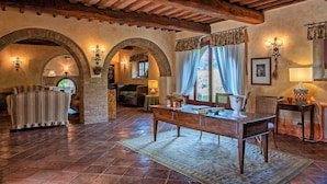 A rustic interior with exposed wooden beams, stone arches, and a wooden table with chairs. - Wonderful private villa with A/C, private pool, WIFI, hot tub, TV, patio, close to San Gimignano (Petrognano)