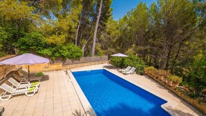 A rectangular swimming pool with a tiled deck, surrounded by trees and a wooden fence. - CAN PERE VELL - Villa with private pool in ANDRATX. Free WiFi (Andratx)