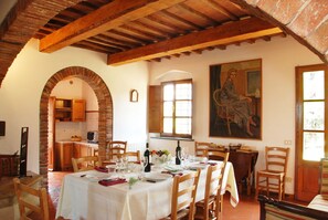 Enjoy meals in this charming dining area with a vaulted ceiling and large painting.