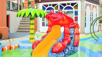 A water park with a large red crab slide and a green palm tree.
