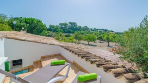A rooftop terrace with a pool, lounge chairs, and a scenic view of trees and hills. - SA ROTA (DEN JOAN PORRERENC) - House with terrace in Montuïri. Free WiFi (Montuïri)