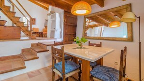A wooden staircase leading to a dining area with a table and chairs. - SA ROTA (DEN JOAN PORRERENC) - House with terrace in Montuïri. Free WiFi (Montuïri)