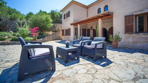 An outdoor patio with wicker furniture and a stone floor. - SA CORBAIA NOVA  - Villa with private pool in Arta. Free WiFi (Artà)