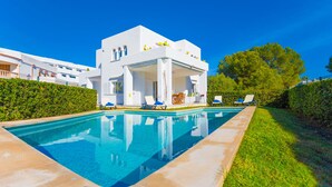 A modern white building with a pool, surrounded by greenery and clear blue skies. - SA CALETA - Villa with private pool in Cala Egos (Santanyi). Free WiFi (Santanyí)