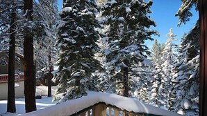 A snow-covered landscape with tall evergreen trees and a wooden fence. - Ski Chalet with Summer Pool Access, Blocks from Heavenly  3411P~ (South Lake Tahoe)