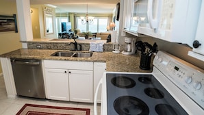 A modern kitchen with granite countertops, stainless steel appliances, and a dishwasher.