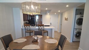 A dining area with a wooden table, chairs, and a central decorative piece.