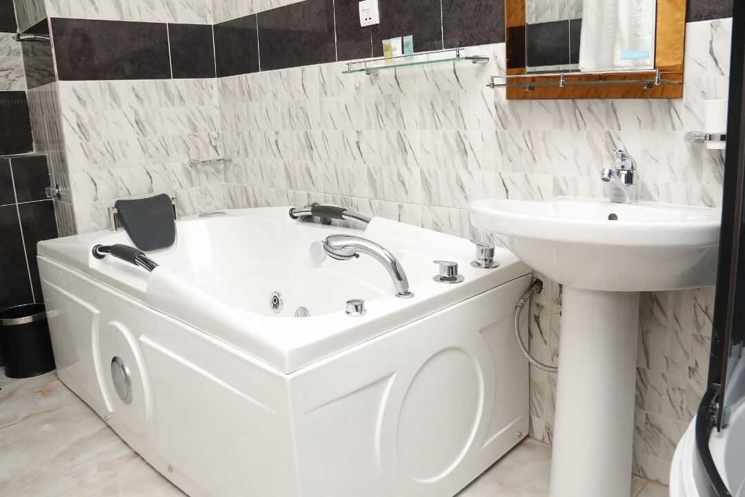 Bathtub, bathrobes, towels, soap