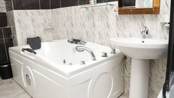 Bathtub, bathrobes, towels, soap