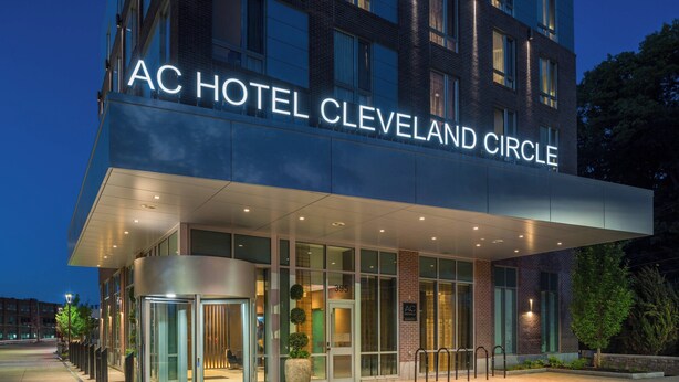 The exterior of the AC Hotel Cleveland Circle with a modern design, large glass entrance, and a well-lit facade. - AC Hotel by Marriott Boston Cleveland Circle (Boston)