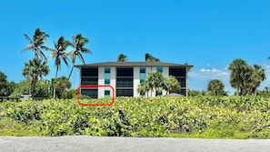 A hotel with a modern design, featuring a two-story structure with a flat roof and large windows.