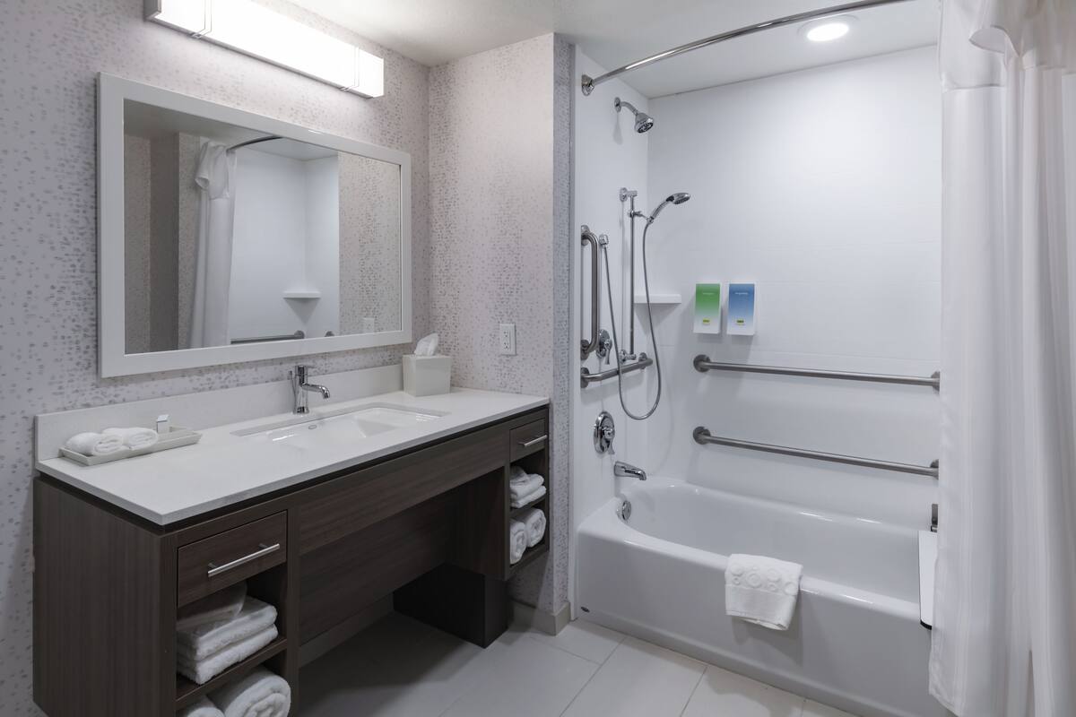 bathtub, free toiletries, hair dryer, towels