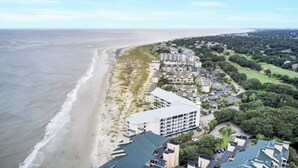 An aerial view of a coastal hotel with multiple buildings, a beach, and surrounding greenery. - 513 Seascape by AvantStay Oceanfront Home w/ Amazing View & Community Pool (Isle of Palms)