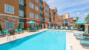 A hotel with a swimming pool, multiple floors, and outdoor seating areas. - Residence Inn by Marriott Spartanburg Westgate (Spartanburg)