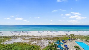 A beach resort with a swimming pool, sun loungers, and umbrellas. - E804 Balcony overlooks the beach! 3 Pools (Panama City)