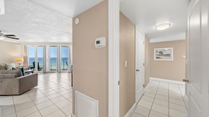A hotel room with a balcony, a ceiling fan, and a view of the ocean. - E804 Balcony overlooks the beach! 3 Pools (Panama City)